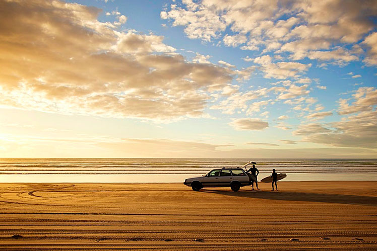 Golden sands and rolling waves make New Zealand's Ninety Mile Beach an irresistible spot to surf until sundown &copy; Amos Chapple / Lonely Planet Images / Getty Images
