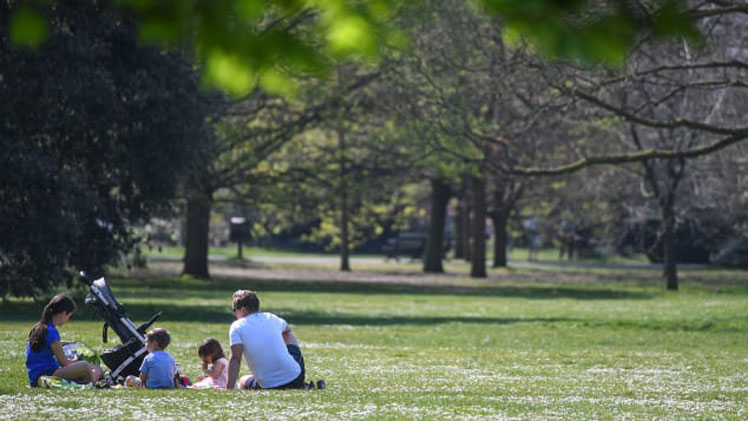 A family enjoy a picnic in London's Greenwich Park in April 2020. Peter Summers/Getty Images