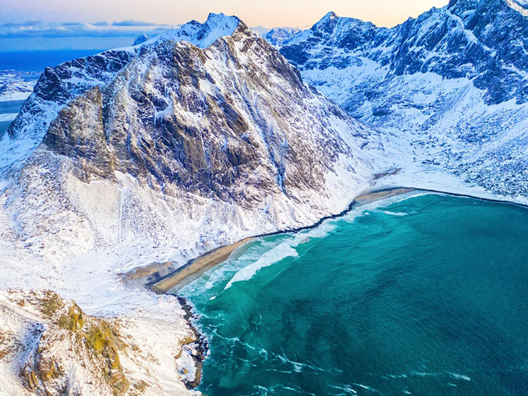 At Kvalvika Beach, tropical-blue waters meet the stark beauty of the Arctic Circle © Feel good studio / Shutterstock