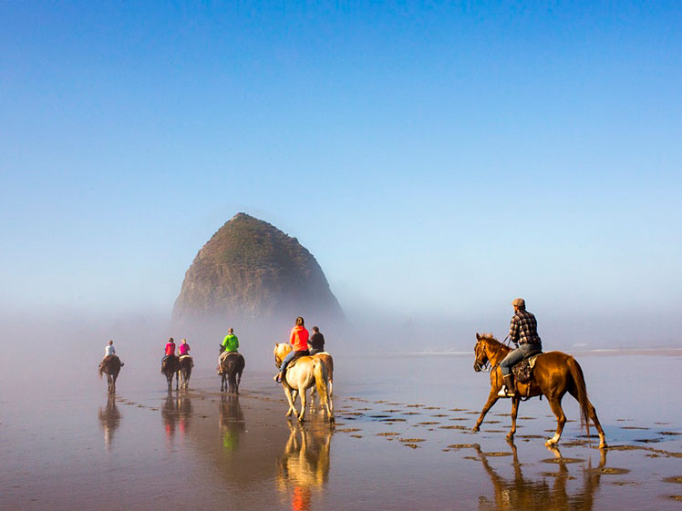 Riding through the infamous mist of Cannon Beach, Oregon © Adam Hester / Shutterstock